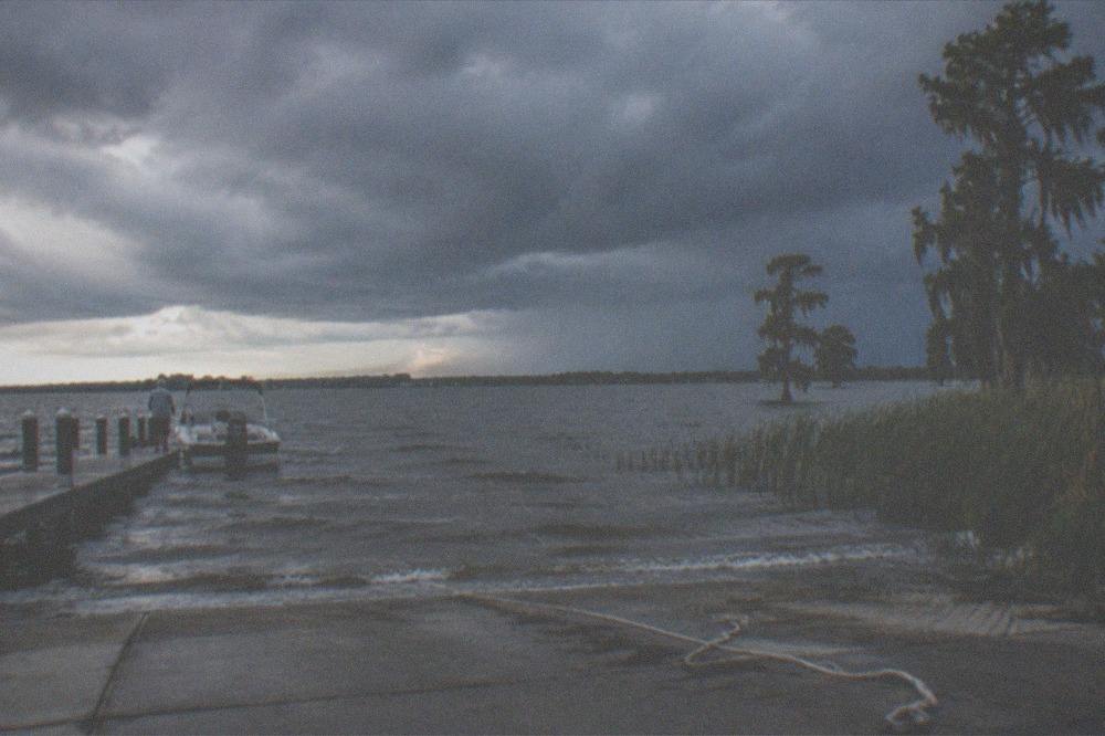 Storm clouds building over a Central Florida lake in late afternoon
