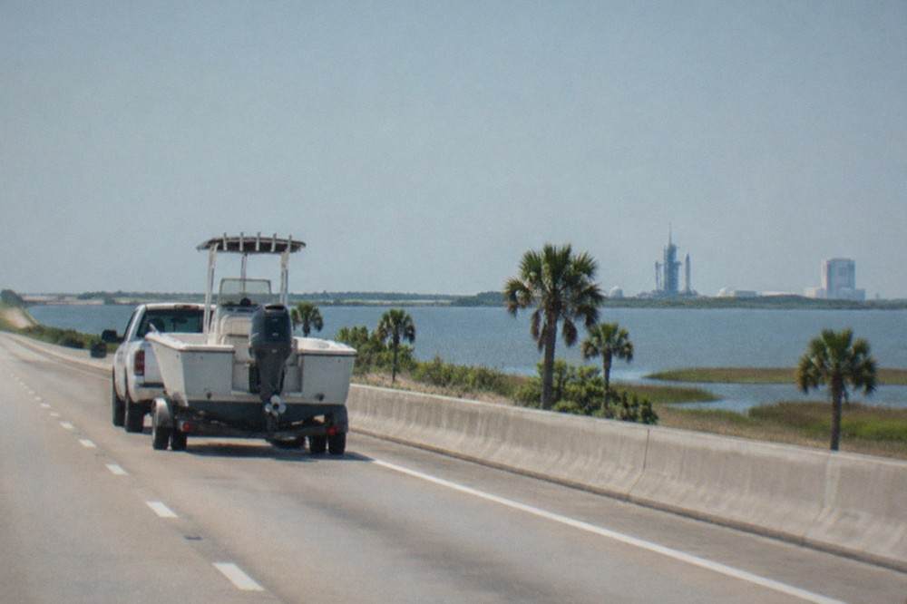 The SR-528 Beachline Expressway heading east toward Port Canaveral with open sky over the causeway.
