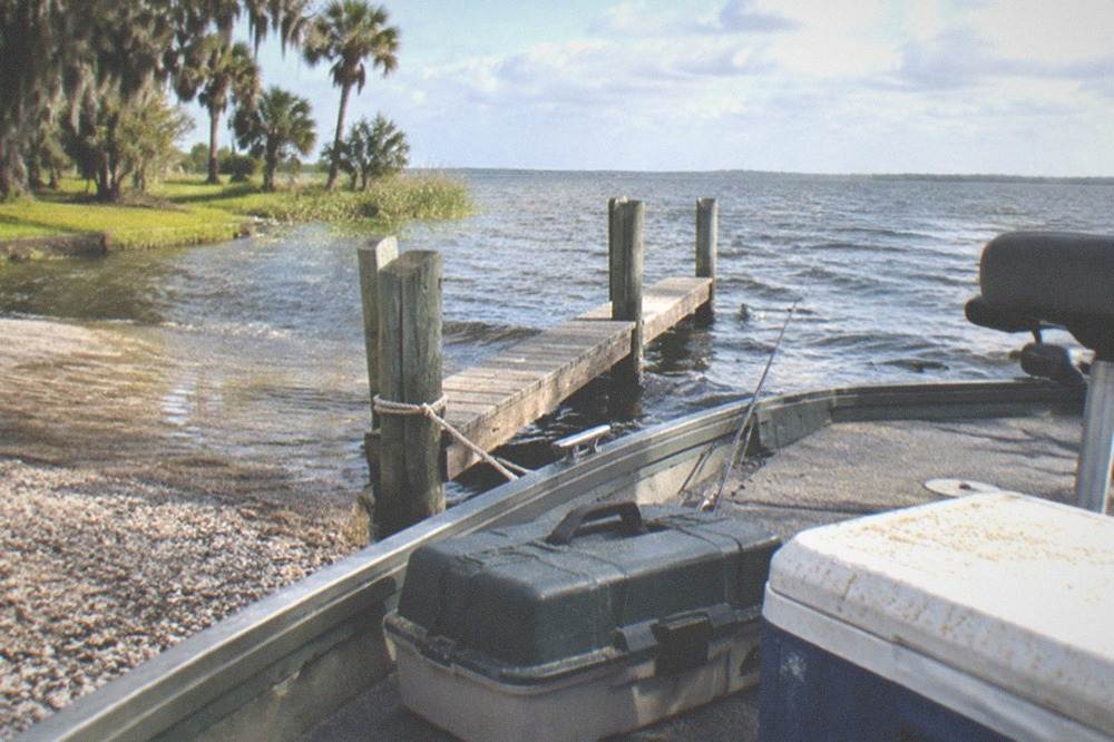 A tackle box and cooler arranged on the deck of a small fishing boat