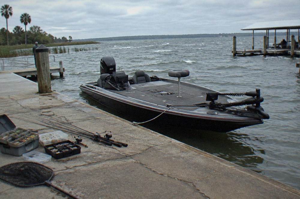 Bass boat at a marina dock on a Florida lake with guide equipment ready