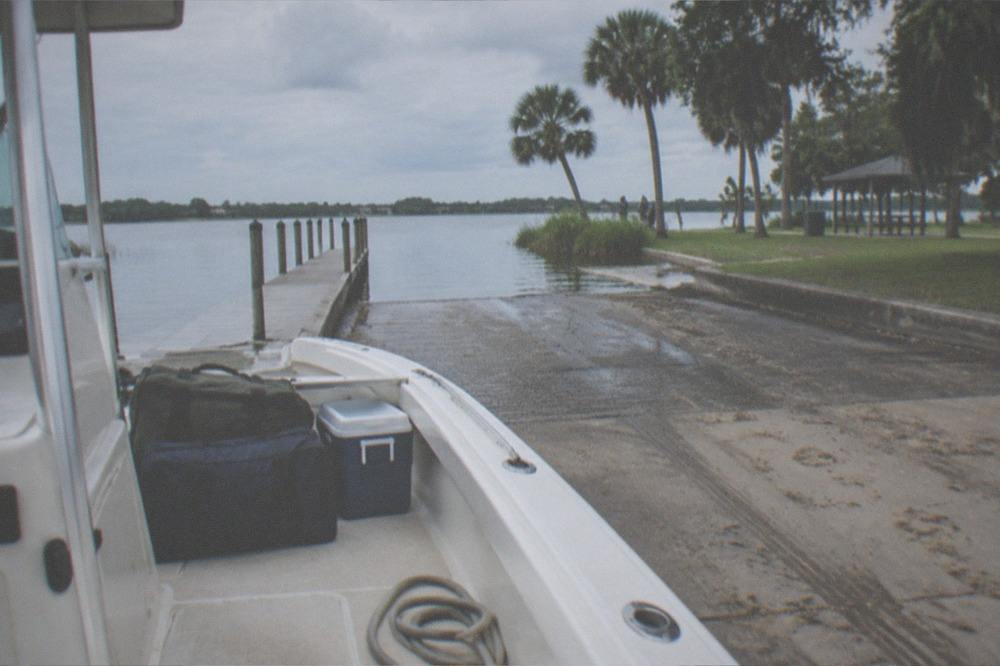 Neatly packed soft bags and a small cooler on the deck of a charter boat ready to depart